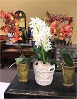Three potted fake plants including orchids and
