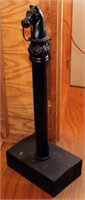 Horsehead hitching post on wooden base.  Wooden