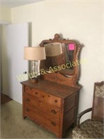 Ornate oak dresser with wishbone mirror and lamp