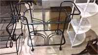 To level metal and glass serving cart on wheels,