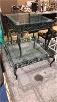 Pair of glass top tables with green iron bases,