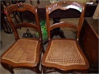 PAIR OF FLORAL CARVED BACK CHAIRS W/ WOVEN SEATS