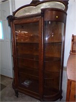OAK CHINA CLOSET WITH BEVELLED MIRROR AND CARVING