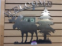 Metal welcome sign with moose and tree