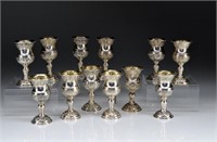 TWELVE SOUTH AMERICAN SILVER FOOTED KIDDUSH CUPS