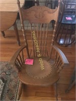 Leather embossed seat carved oak rocking chair