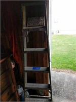 6 foot aluminum step ladder and items in corner