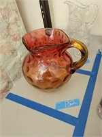Amberina thumbprint pitcher with chip on lip