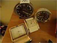 4 vintage alarm clocks.