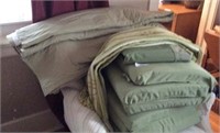 Grouping Of Green Cushions Rug Comforter Etc