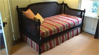Black painted wicker day bed, with trundle bed