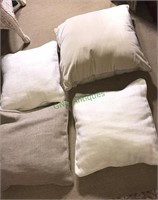 Four beige designer pillows (FR)