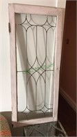 Leaded glass cabinet door set up to hang on the