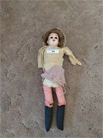 Antique porcelain doll in poor condition