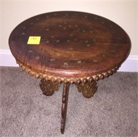 Ornate carved small round table