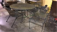 Black metal table and four chairs patio set,