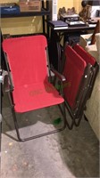 Three nice folding red cloth chairs with arms,