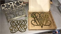 Two Virginia metal crafters brass trivets, one is