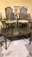 Vintage dining table with six chairs with cane
