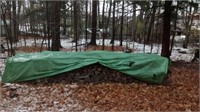 wood under green tarp