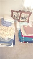 lot of bed linens, bed pillows, decorative pillows