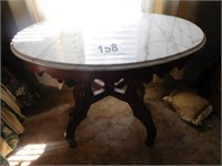 Oval marble top cherry base tear drop table