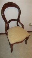 Antique wood side chair with ornate carving and