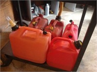 Lot of 5 small gas cans.