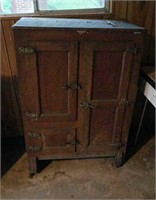 Antique ice chest has a missing castor
