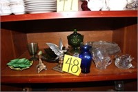 two shelves of misc .; glass platters;