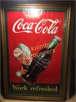 Framed Coca Cola advertising poster