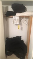 Bedding and hangers in closet