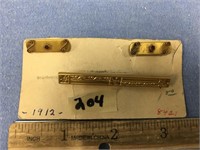A tie pin and two small pins dated 1912      (3)