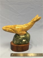 10" long soapstone whale mounted on a hard wood an