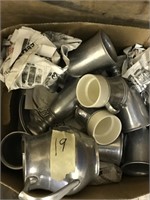 Box of silver colored decorative cups and pitc