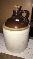 1 gallon brown and white stoneware jug with the