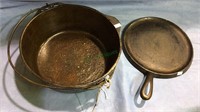 Cast iron Dutch oven and iron flat pan , both