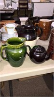 Two pottery pitchers and a pottery teapot with