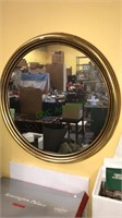 Round wall mirror with a gold frame, 27 inches in