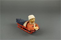 Boy on Sled Tin Toy