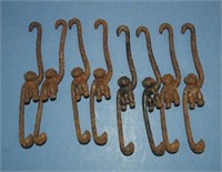 Eight cast iron monkey hooks
