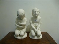 Two bisque porcelain kneeling figures