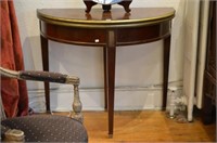 Mahogany demi lune games table w/brass banding