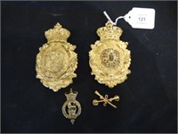 Two brass military badges with accessories