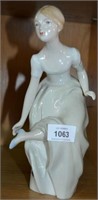 Royal Dux figurine of a woman removing shoe,