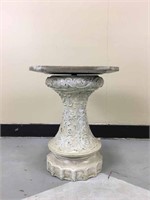 A small plant stand or a pedestal.