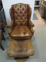 Un fauteuil en cuir avec appuie pied en cuir