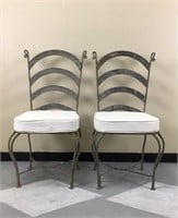 Pair of cast iron dining chairs with tan