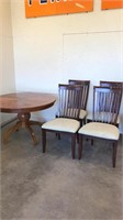 Round kitchen table and four chairs, table top is