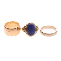 A Pair of Gold Wedding Bands and Lapis Ring